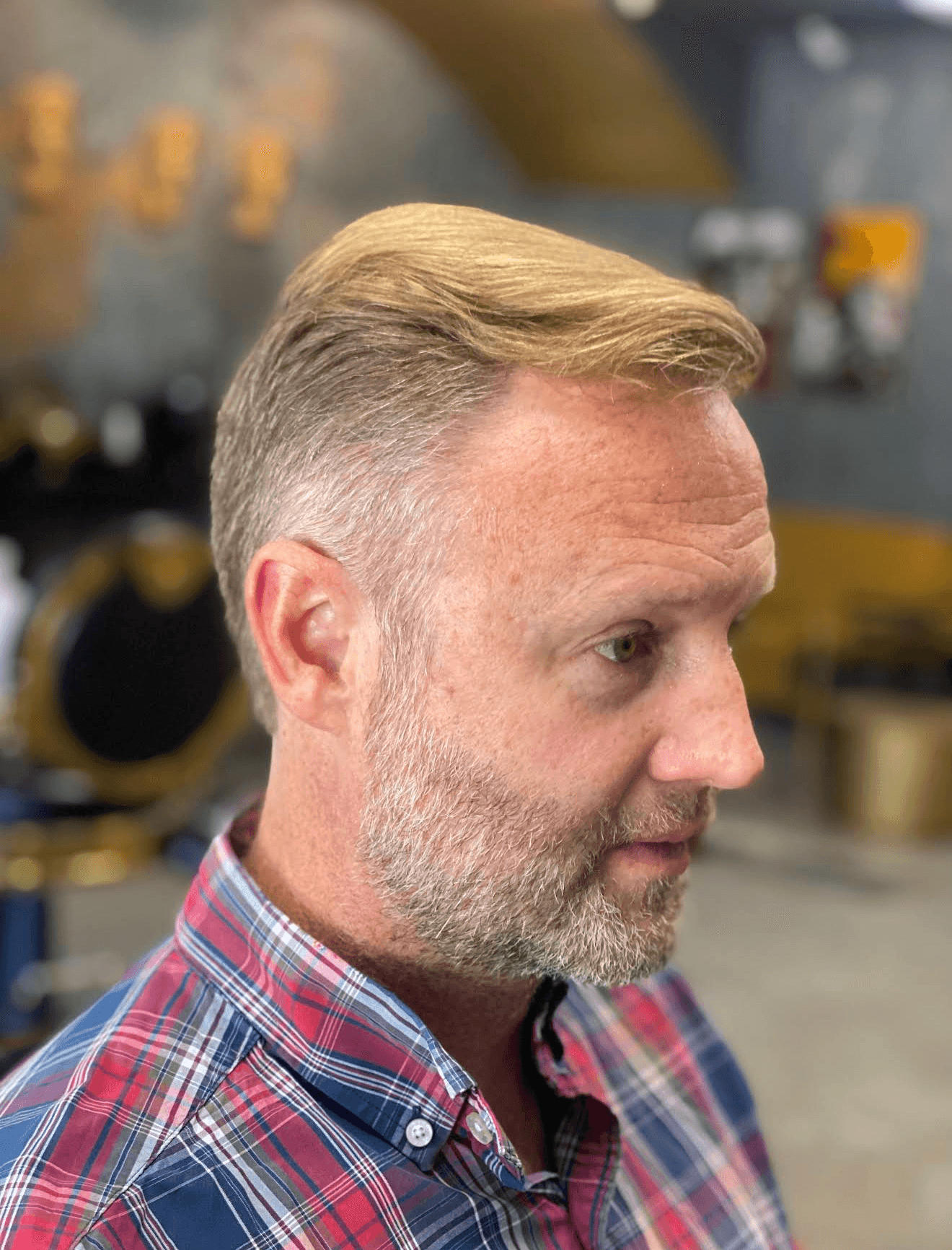 Styled side part with trimmed beard
