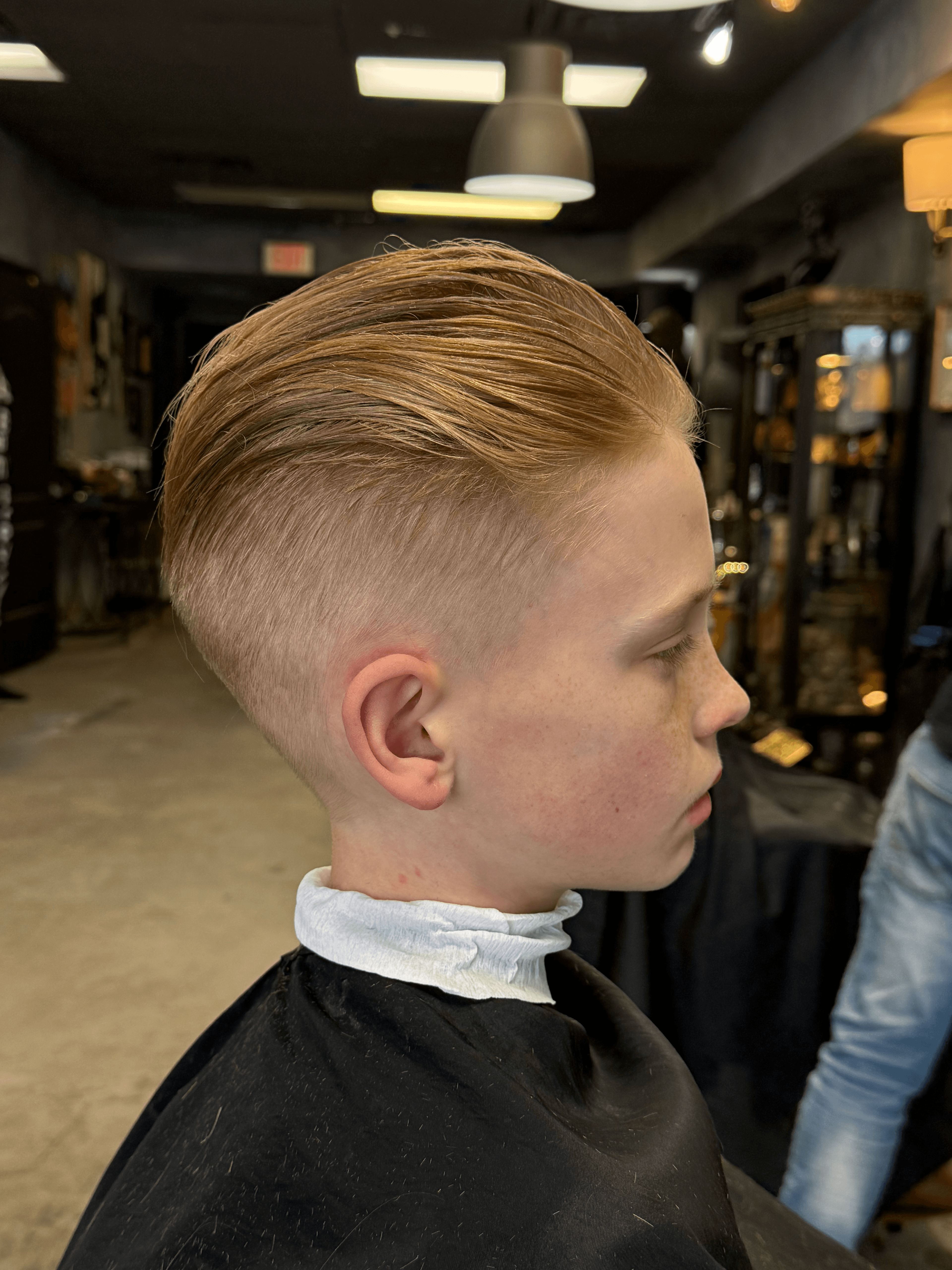 Slicked back cut on young client